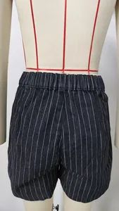 Detailed view of striped washed denim shorts with elastic waistband on mannequin