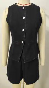 Close-up of a women's black denim sleeveless vest and shorts set on a mannequin.