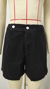 Detailed view of black washed denim shorts featuring a double button waistband style