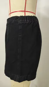 Close-up detail of black washed denim mini skirt featuring an elastic waistband