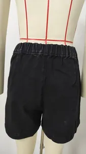 Rear view of black high-waisted denim shorts on a mannequin form