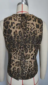 Detailed back view of a sleeveless leopard print washed denim vest with a tailored fit