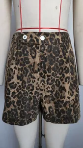 Detailed view of leopard print denim shorts with double button waist