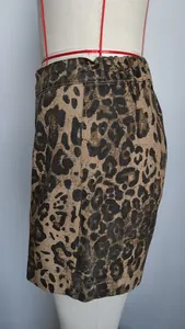 Detailed side view of a women's leopard print denim mini skirt on a mannequin torso