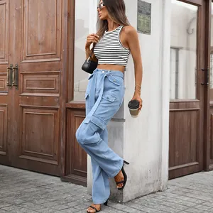 Detailed view of high waisted light blue washed denim cargo pants with functional pockets