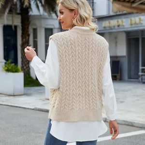 Close-up back view of a beige cable knit sweater vest showing retro twist texture