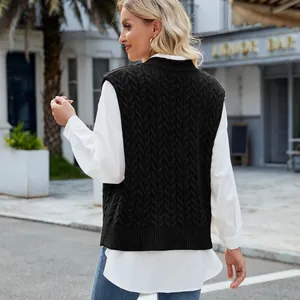 Back view of a black cable-knit sweater vest showcasing the intricate woven texture