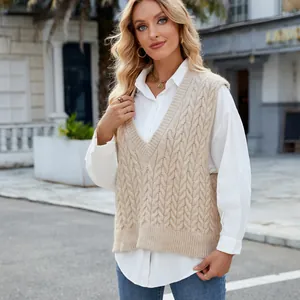 Vintage beige cable knit V-neck sweater vest styled with a white shirt on a model