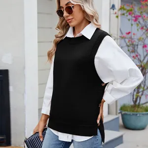 Detail view of black knit sweater vest with side buttons and split hem layering.