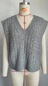 Detailed texture view of grey retro cable knit pattern on a V-neck sleeveless sweater vest