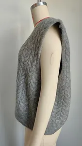 Side view detail of a grey vintage cable-knit V-neck sweater vest on a mannequin