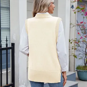Back view of a cream knitted sweater vest featuring side slits and decorative gold buttons