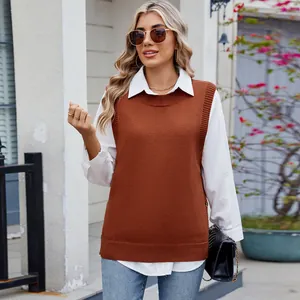 Outdoor street style shot of a woman wearing a casual brown knitted sweater vest and shirt