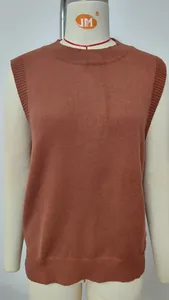 Detail view of the fine ribbed texture on a casual rust red sleeveless knitted vest