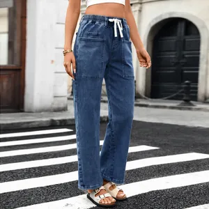 Detailed shot of women's blue denim drawstring pants with utility cargo pockets