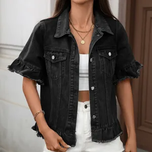 Close-up of black washed denim short sleeve jacket with ruffle trim hem