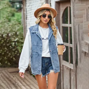 Detailed view of a trendy women's oversized blue denim vest with functional pockets.