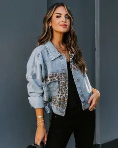 Fashionable denim jacket featuring leopard print patchwork and distressed details on a model