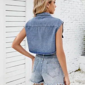 Back view of a trendy light wash cropped denim vest and frayed denim shorts set.