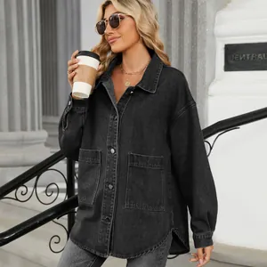 Stylish woman in an oversized black washed denim jacket holding coffee in urban setting