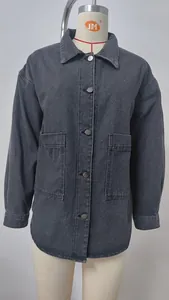 Macro detail view of charcoal washed denim jacket featuring large front utility pockets