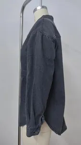 Side profile view of a vintage washed black oversized denim jacket for women, detail