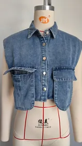 Close-up of a cropped washed denim vest with large front pockets and metal buttons