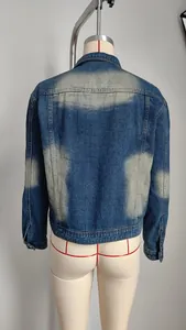 Detailed back view of a blue washed denim jacket featuring vintage bleached fade effects
