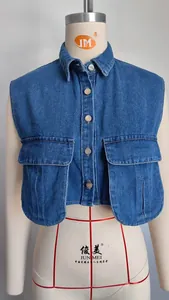 Detail of blue washed denim cropped vest with two large flap pockets on mannequin