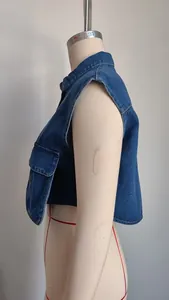 Side view of women's washed blue denim vest featuring large pockets and classic collar.