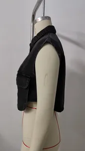 Side view of a washed black denim cropped vest with a functional front pocket