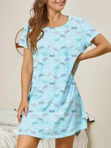 A detailed view of a light blue butterfly print nightgown on a model in a bedroom.