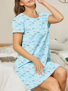 Detailed view of women's light blue nightgown featuring a butterfly and polka dot print.