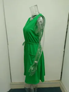 Side view detail of a vibrant green sleeveless summer dress with drawstring waist and pockets