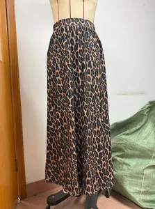 Close-up detail of the leopard print fabric and elastic waistband of a midi skirt.