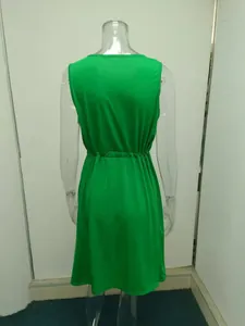 Detailed back view of a vibrant green sleeveless summer dress with elastic waist detail