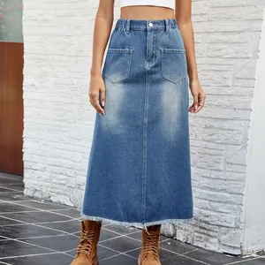 A detailed view showing the high-waist design, front pockets, and frayed hem of this denim skirt