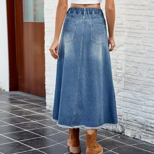 Washed blue A-line long denim skirt with frayed hem and elastic waist, back view detail.