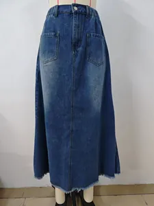 Detailed view of a washed blue denim midi skirt featuring a frayed hem and elastic waist