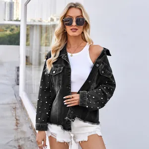 Detail einer gewaschenen schwarzen Jeansjacke mit Perlen und Fransensaum am Modell