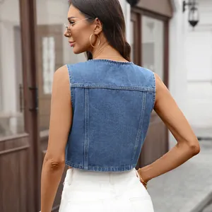 Close-up back view of a blue washed denim vest with a cropped fit and classic crew neck
