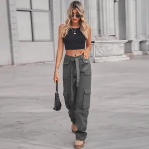 Outdoor street style shot showing detailed multi-pocket design on washed denim cargo pants