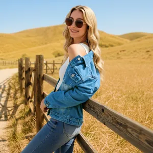 Outdoor view of a stylish blue distressed denim jacket featuring metal buttons and loose fit
