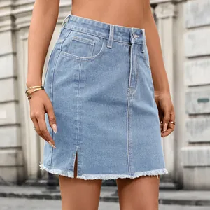 Close-up of a light blue washed denim mini skirt featuring a front slit and raw hem detail.