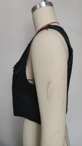 Side detail view of a black washed denim vest showing the armhole and flap pocket