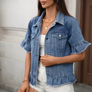 Detail view of stylish women's short sleeve denim jacket with ruffle fringe hem and raw edges