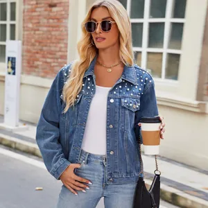 Stylish women's denim jacket with pearl embellishments and a washed finish look