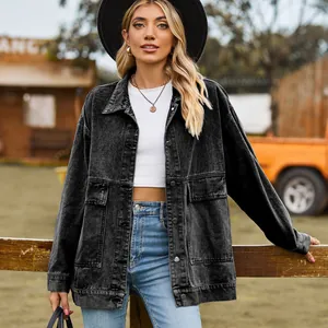 Classic black denim jacket with distressed finish on a model in a ranch setting