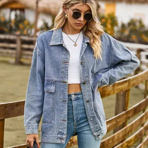 Detailed view of a stylish light blue oversized retro denim jacket worn by a fashion model.