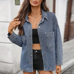 Close-up detail of washed retro denim shirt with loose casual fit and silver metal buttons
